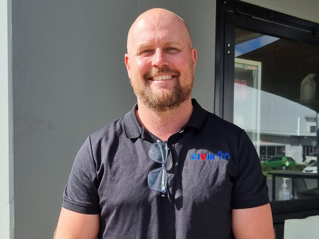 Chris Fortnam smiles in a blue Civik polo