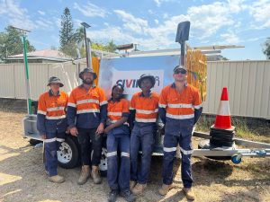 Inaugural Townsville crew - five people in hi-vis stand in front of a Civik trailer