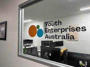 Youth Enterprises Australia logo on a window